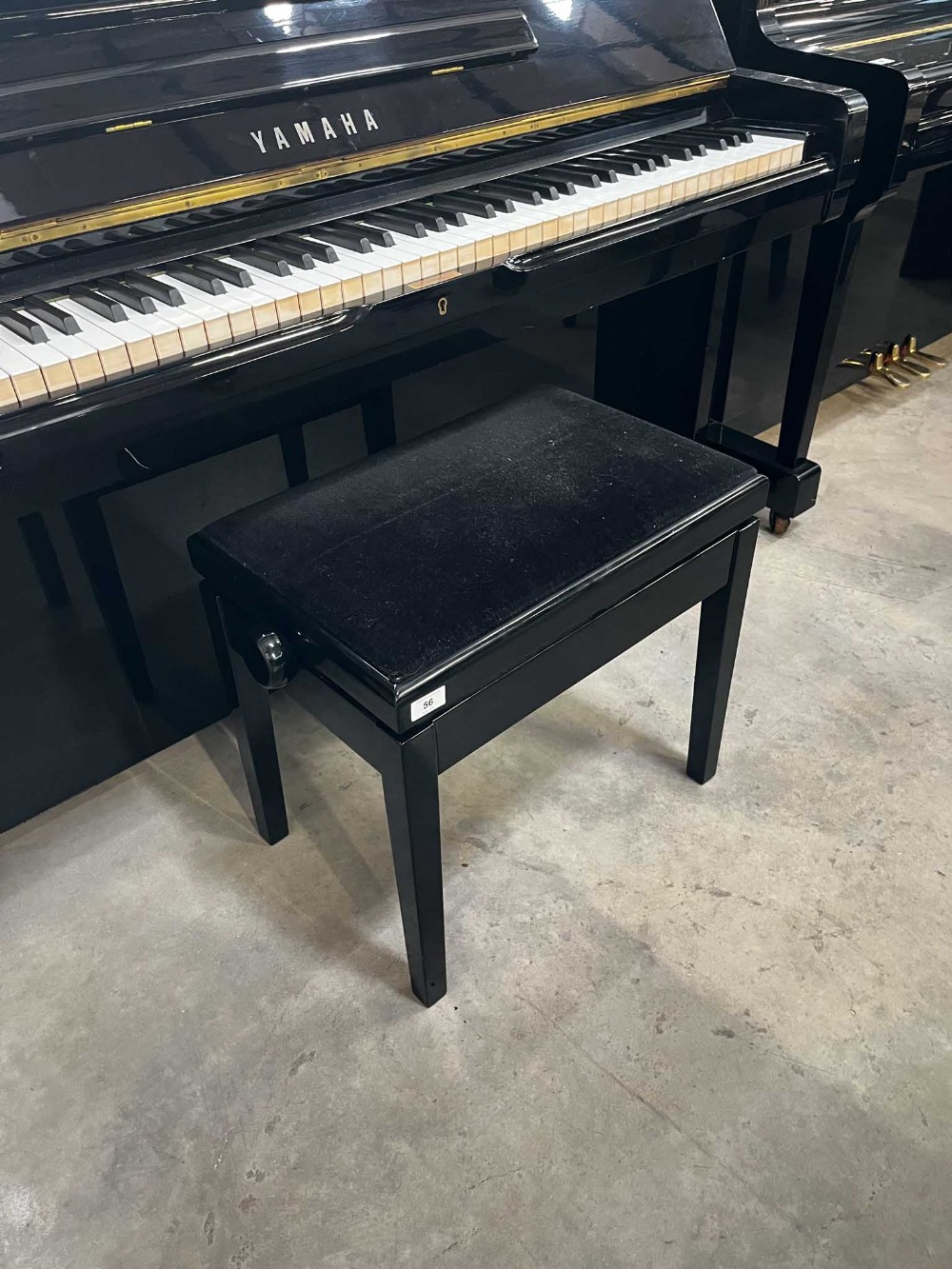 Yamaha (c1974) A Model U2 upright piano in a bright ebonised case; together with a matching stool. - Image 5 of 5