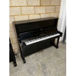 Yamaha (c1975) A Model U1 upright piano in a traditional bright ebonised case.
