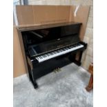 Yamaha (c1973) A Model U1 upright piano in a bright ebonised case.