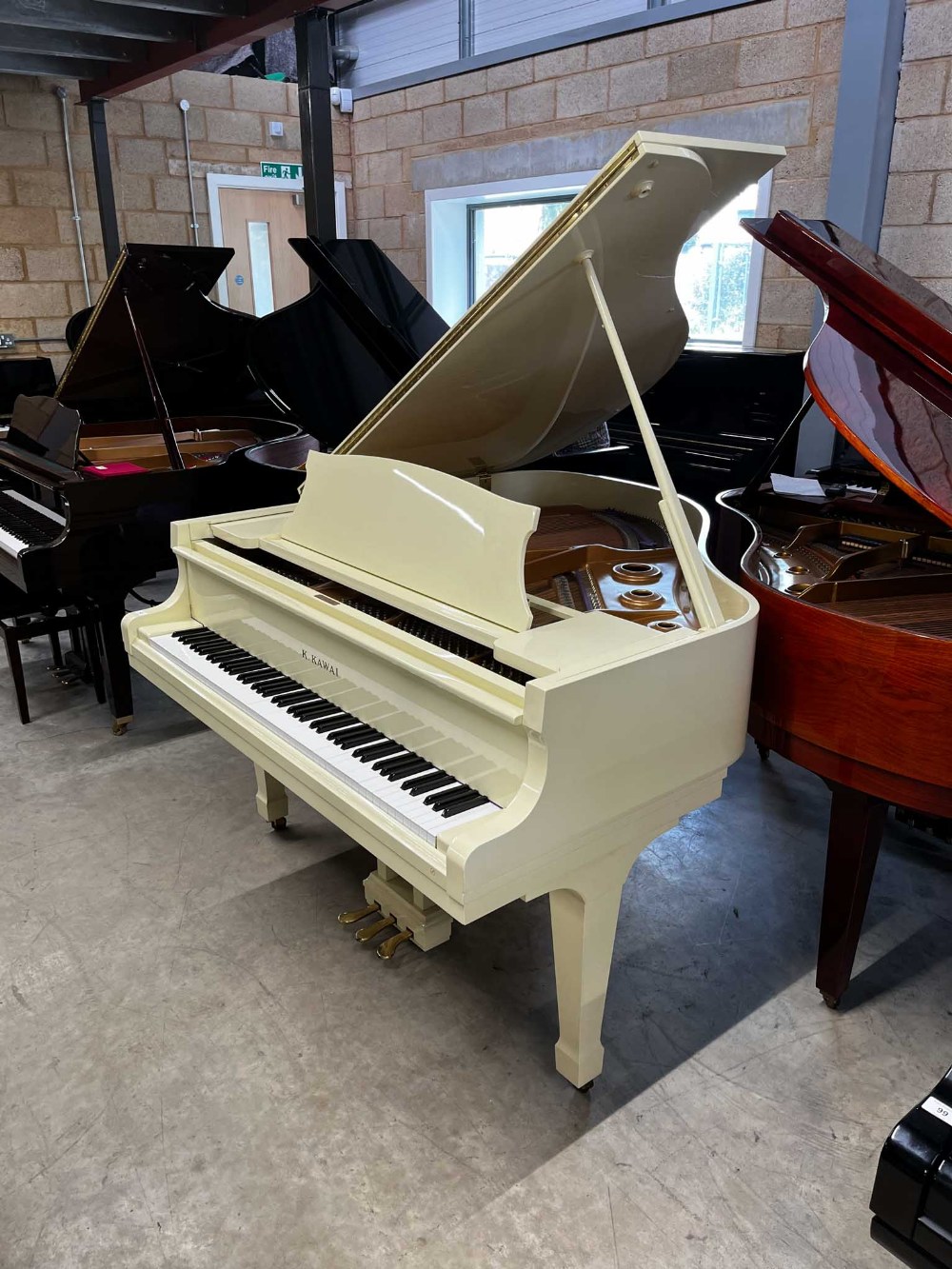 Kawai (c1984) A 5ft 1in Model KG-1D grand piano in a cream case on square tapered legs; together