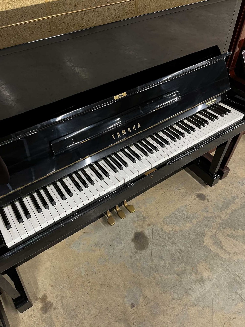 Yamaha (c1977) A Model U1 upright piano in a traditional bright ebonised case; together with a - Image 2 of 5