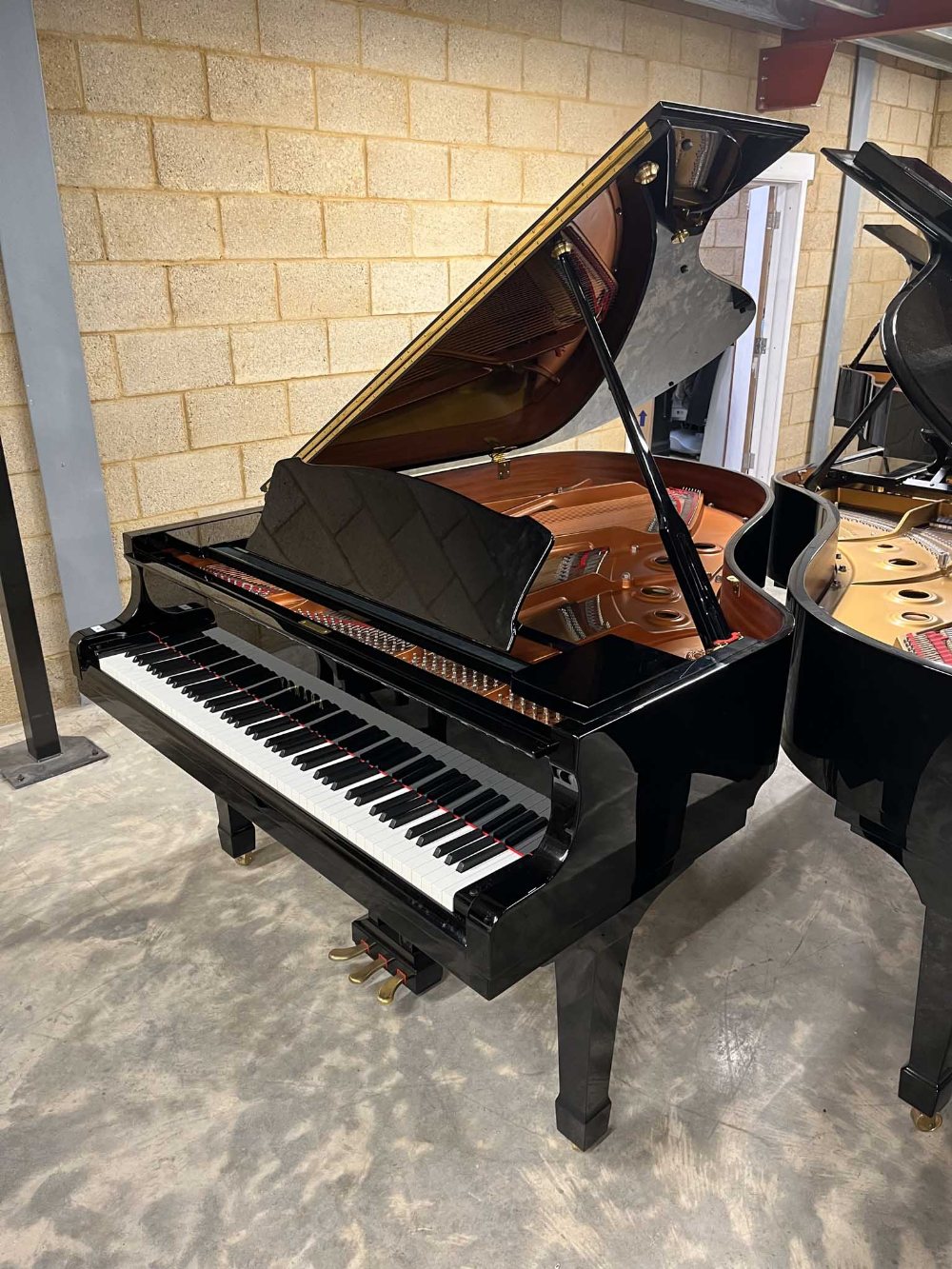 Yamaha (c2010) A 6ft 1in Model C3 grand piano in a bright ebonised case on square tapered legs;