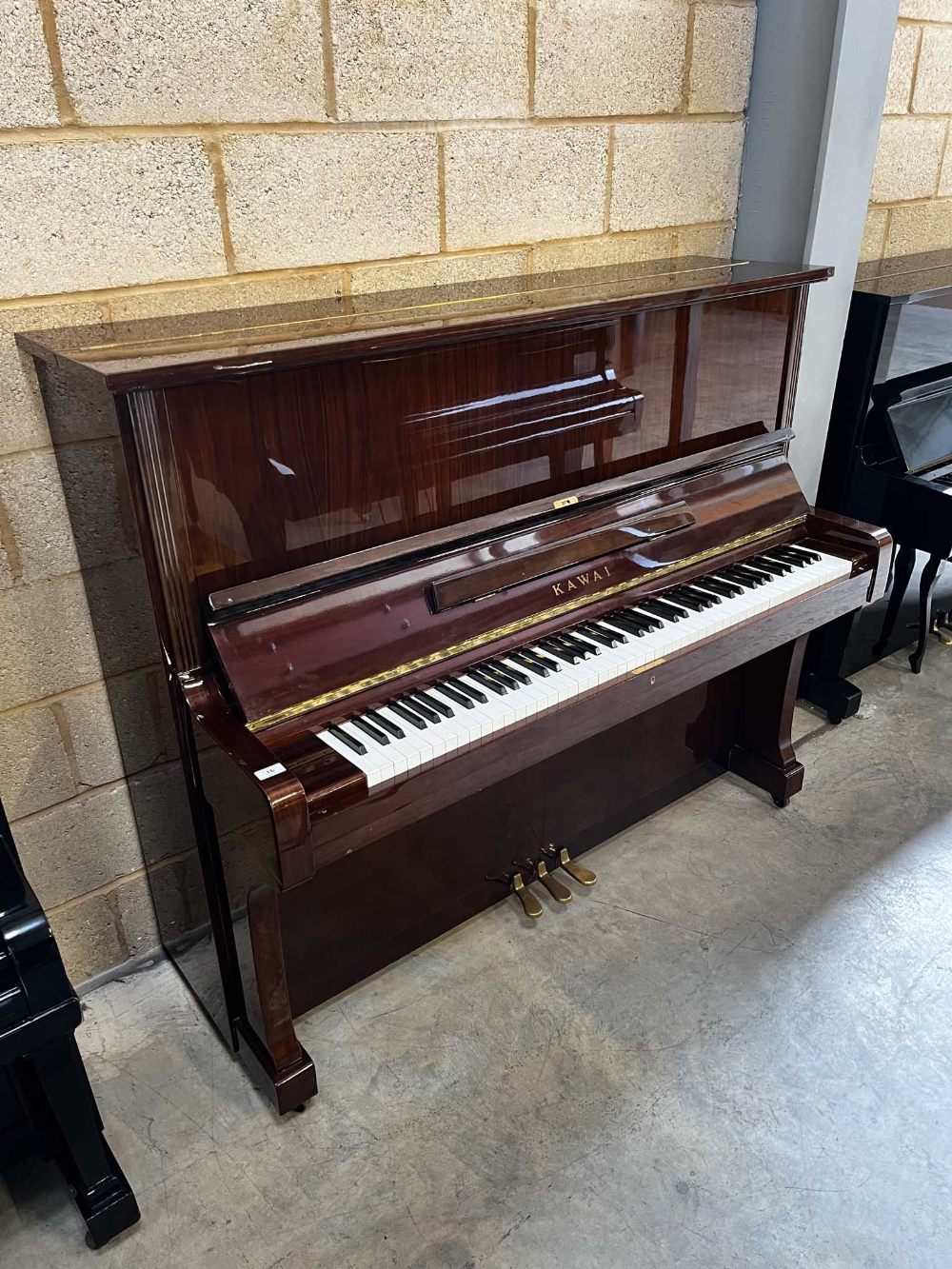 Kawai (c1976) A 132cm Model BL-61 upright piano in a traditional bright mahogany case; together with