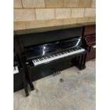 Yamaha (c1977) A Model U1 upright piano in a traditional bright ebonised case; together with a