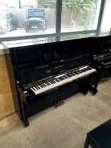 Yamaha (c1974) A Model U2 upright piano in a bright ebonised case; together with a matching stool.