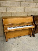 Hyundai (c1991) A Model U852 upright piano in a light oak case.