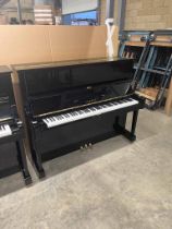 Yamaha (c1976) A Model U1H upright piano in a traditional bright ebonised case.