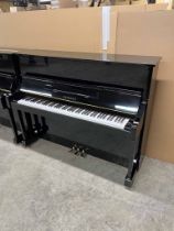 Yamaha (c1999) A Model YM10 upright piano in a traditional bright ebonised case.