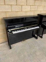 Schimmell (c2006) An upright piano in a traditional bright ebonised case.