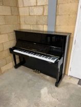 Yamaha (c1974) A Model U1H upright piano in a traditional bright ebonised case.