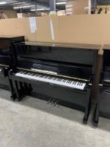 Yamaha (c1991) A Model U10A upright piano in a traditional bright ebonised case.