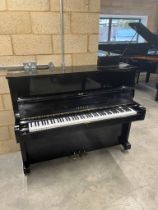 Yamaha (c1971) A Model U1 upright piano in a bright ebonised case.