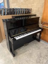 Yamaha (c1990) A Model U10BL upright piano in a traditional bright ebonised case.