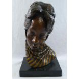 A head study of an African lady wearing a scarf, bronze with gilt detail, on rectangular plinth,