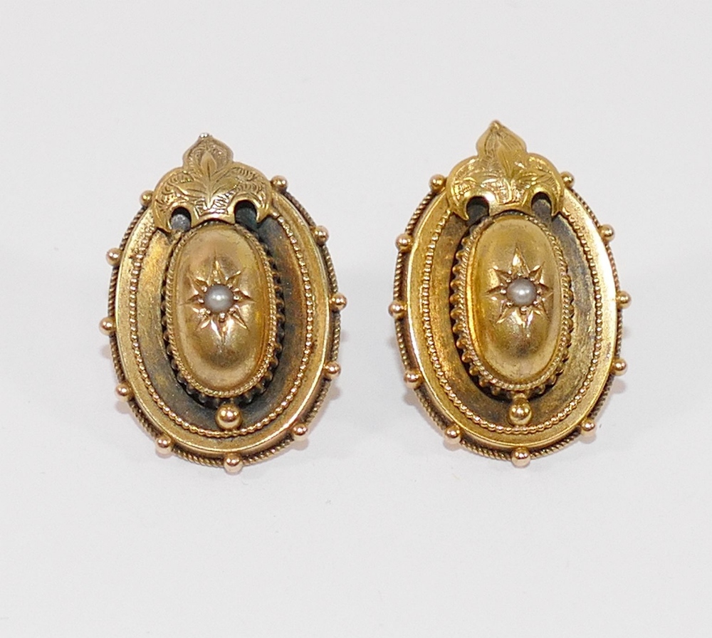 A pair of Victorian hollow gold oval earrings, each centrally set with a half seed pearl, with later