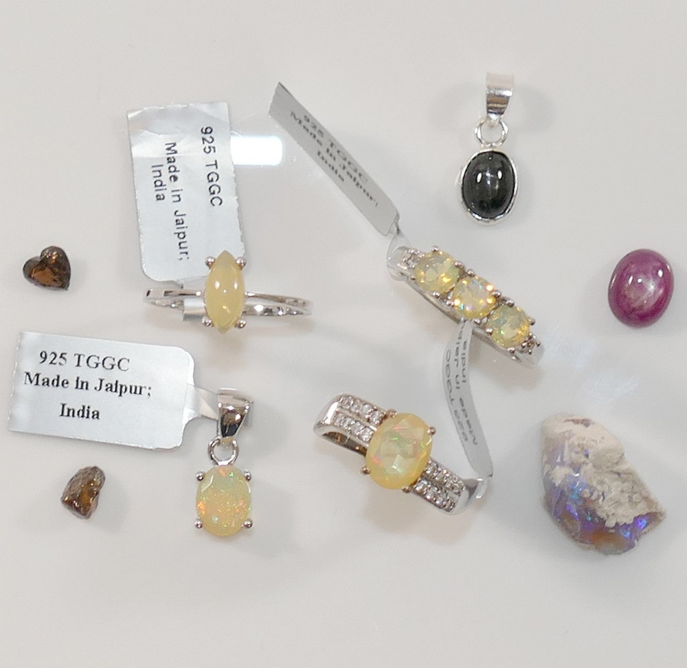 Three modern Ethiopian opal set rings, stamped '925', a similar opal pendant, also stamped '925',