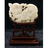 A Chinese carved stone panel in the form of a cat, 6cm long, on hardwood stand, and a pierced and