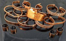 Ten hand made copper bangles, and four copper rings, designed to help prevent the wearer from the