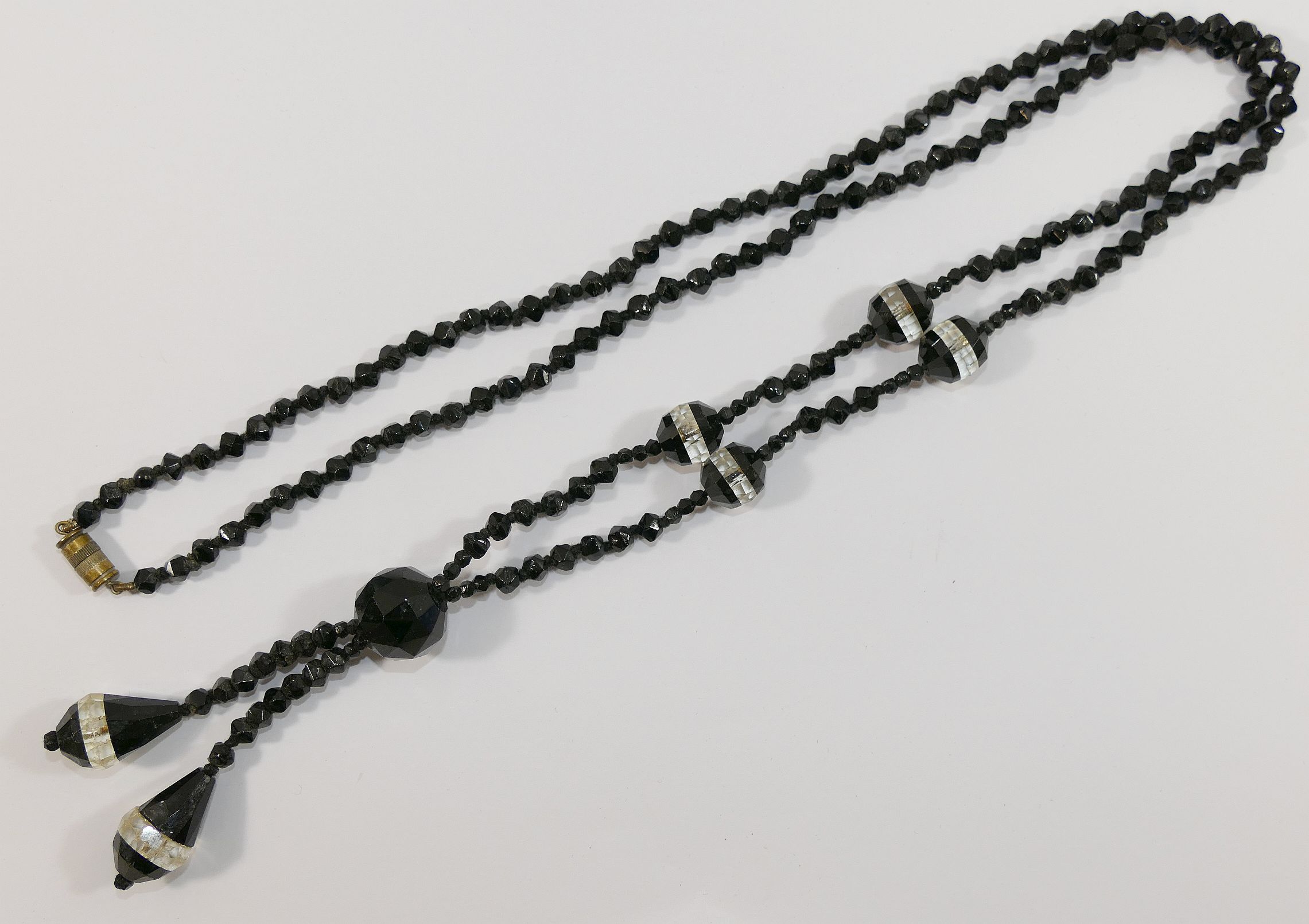 A string of 19th century black and clear paste faceted beads, and other 19th century and later