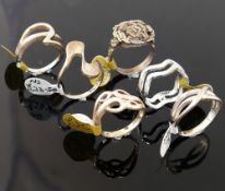 Twelve modern silver and other rings stamped '925' or 'silver', various designs and sizes. We are