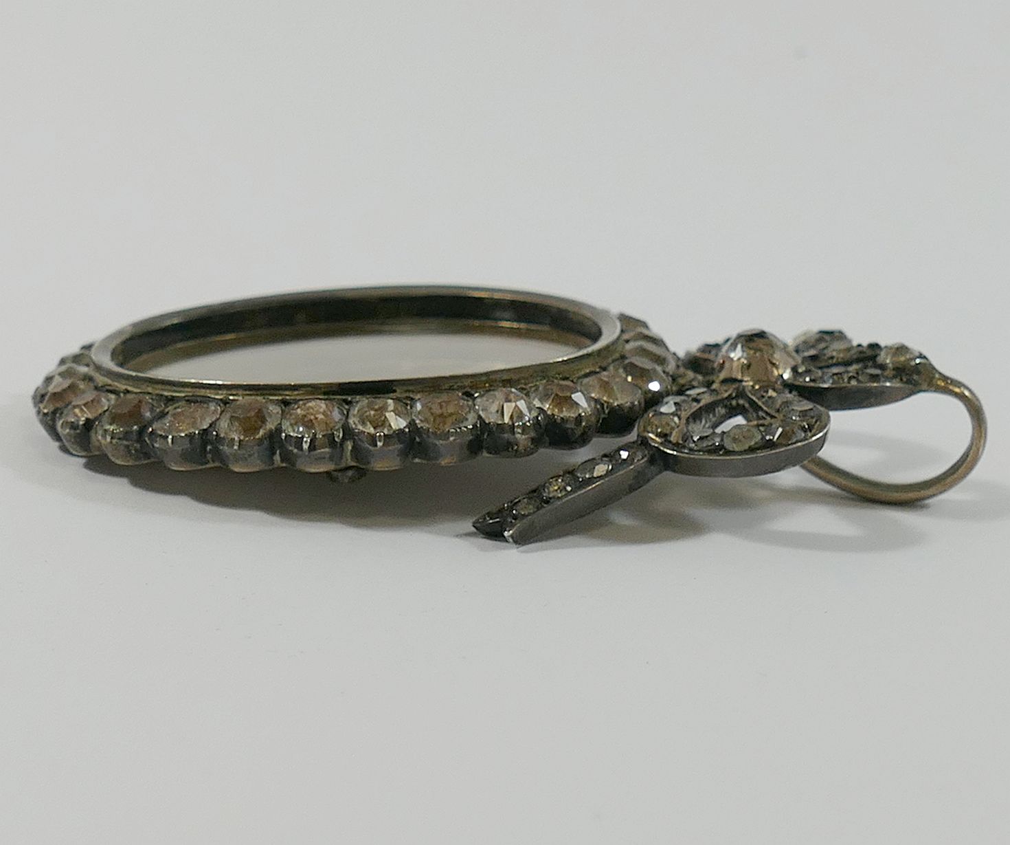 A large 19th century paste set silver locket, with hinged back and bow surmount, 7.5cm long x 4. - Image 3 of 3