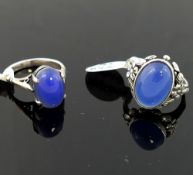 A selection of blue agate jewellery comprised of a large oval brooch, 6cm wide, a smaller brooch,