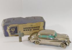 A Prameta Kolner Automodelle clockwork silver Mercedes-Benz 300, 14.3cm long, with original