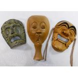 A collection of six wooden and one pottery wall masks and ornaments including ethnic, theatrical and