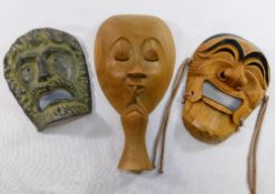 A collection of six wooden and one pottery wall masks and ornaments including ethnic, theatrical and