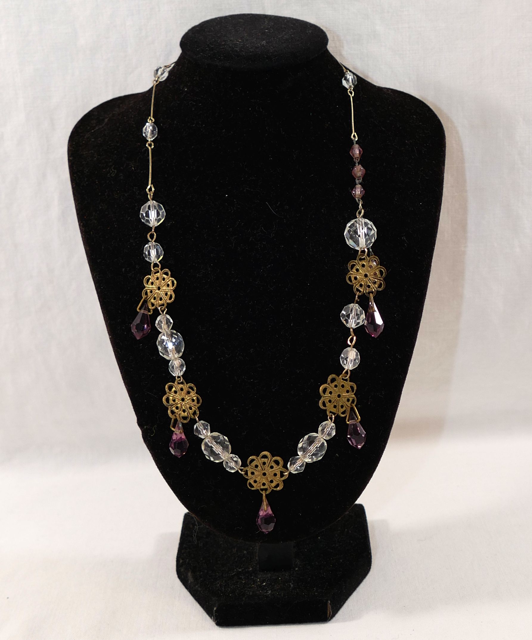 Five early 20th century and later paste set necklaces, including  a gold plated example set with