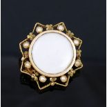 A small French gold seed pearl set brooch, with central circular glazed keepsake panel, and a