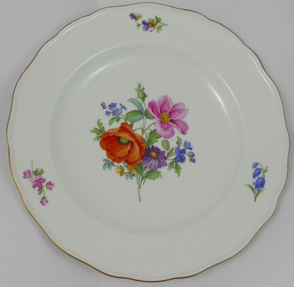 A set of four Meissen style porcelain soup plates, hand painted with floral sprays, with wavy gilt