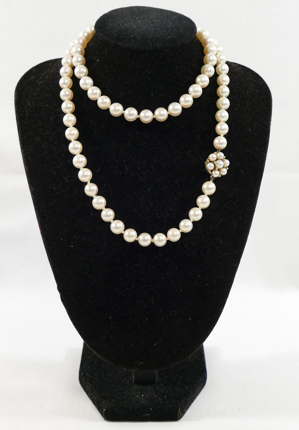 A string of individually knotted cultured pearls, each approximately 7mm diameter, the yellow
