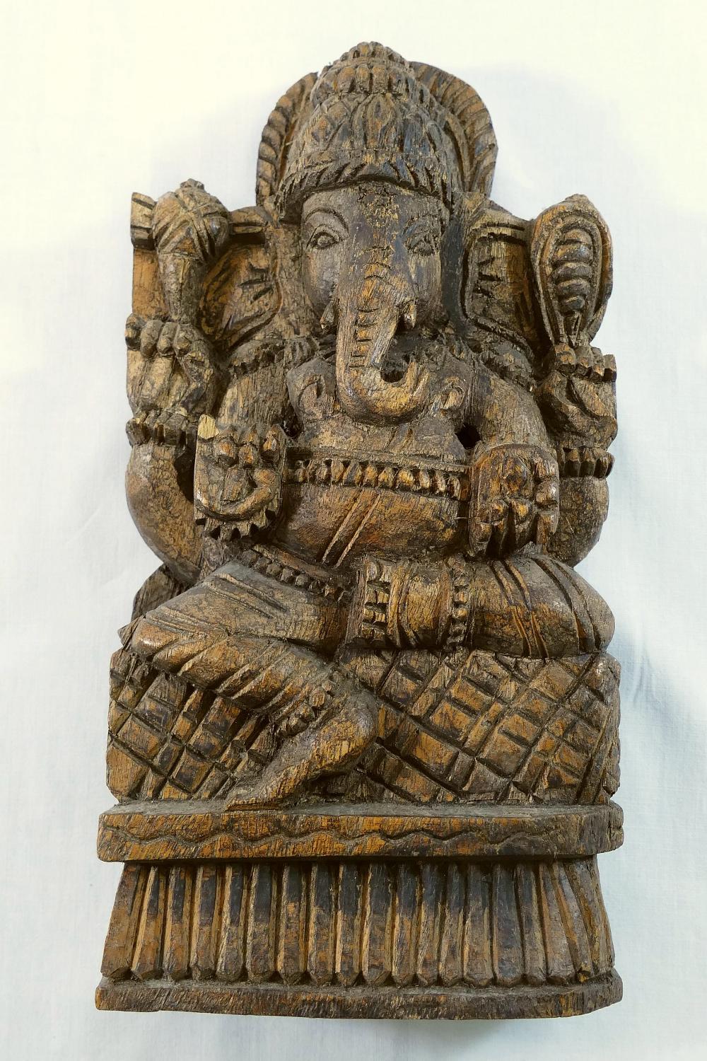 A carved wooden panel of Hindu god Ganesh, 28cm high, and another Indian figural carved wooden