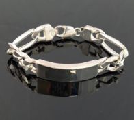 A heavy silver identity bracelet, the rectangular panel 13mm wide with Figaro links We are pleased