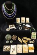 An assortment of rainbow lustre bead jewellery, paua shell set items, mother of pearl cuff links,