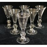 A set of six wine glasses with conical bowls, the knopped stems containing a single tear air bubble,