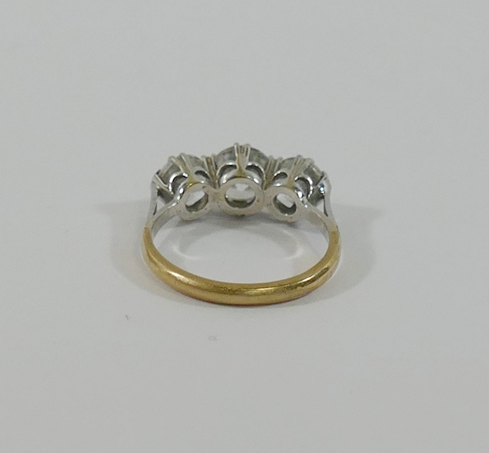 A 9 carat gold diamond simulant three-stone ring, the stones claw-set in white to a yellow shank, - Image 3 of 3