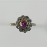 A 19th century diamond and garnet oval cluster ring, the central oval garnet set within a chip-cut