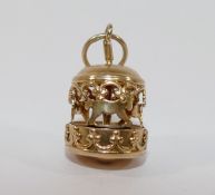 A yellow metal four-section puzzle ring, finger size V1/2, a yellow metal merry-go-round charm and a