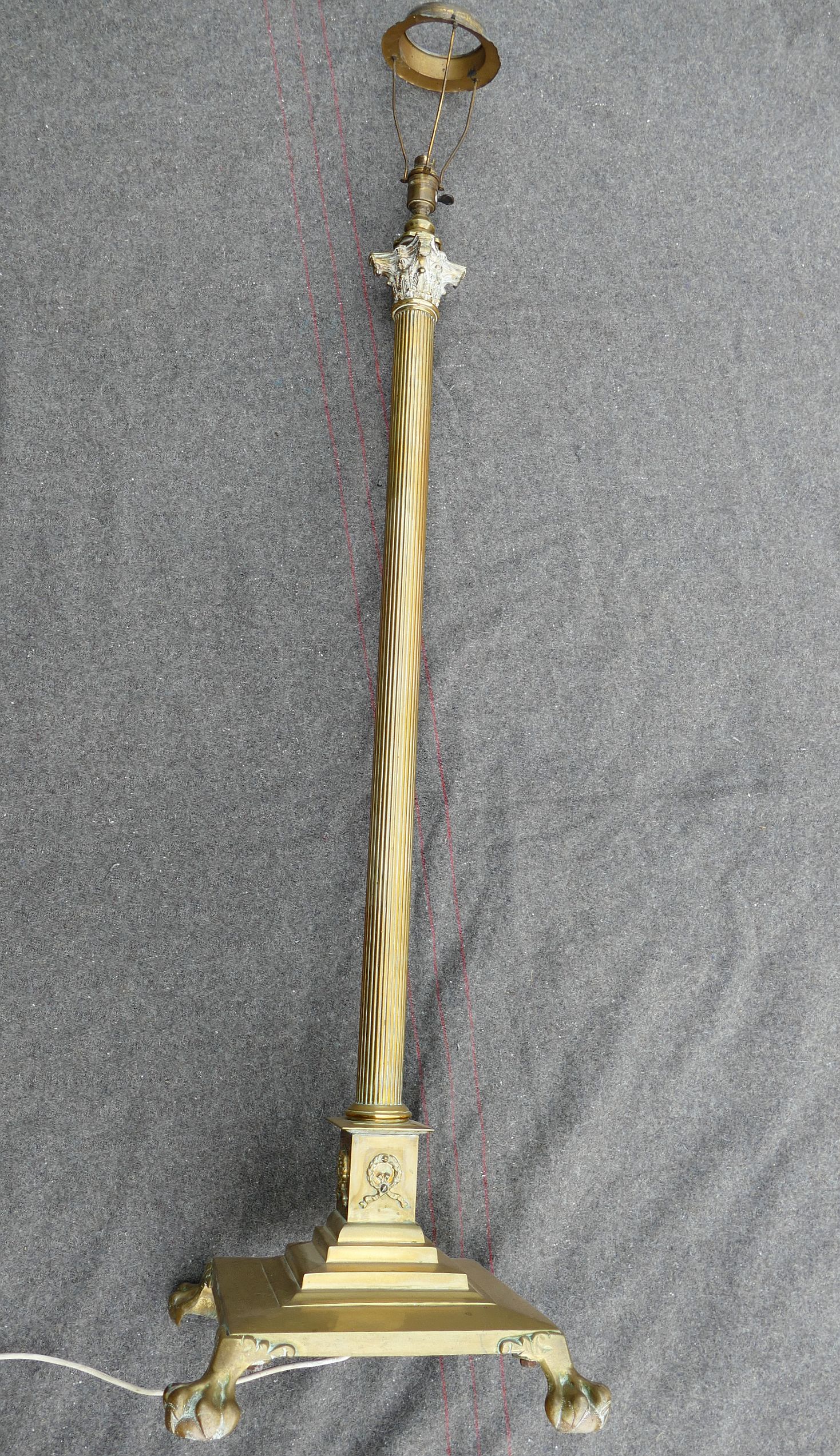 An early 20th century brass telescopic Corinthian column standard lamp, raised on square base with