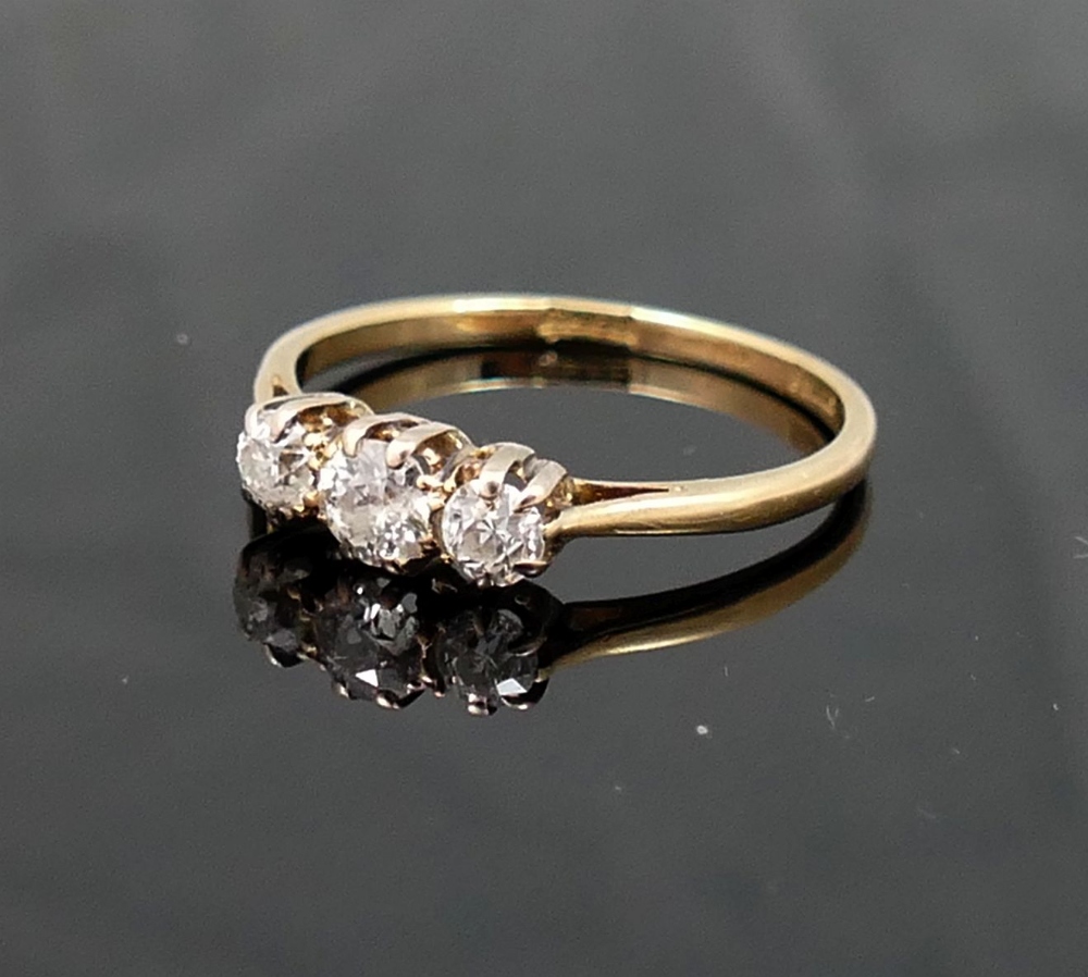 A diamond three-stone ring, the graduated old-cut stones approximately 0.15, 0.23 and 0.15 carats,