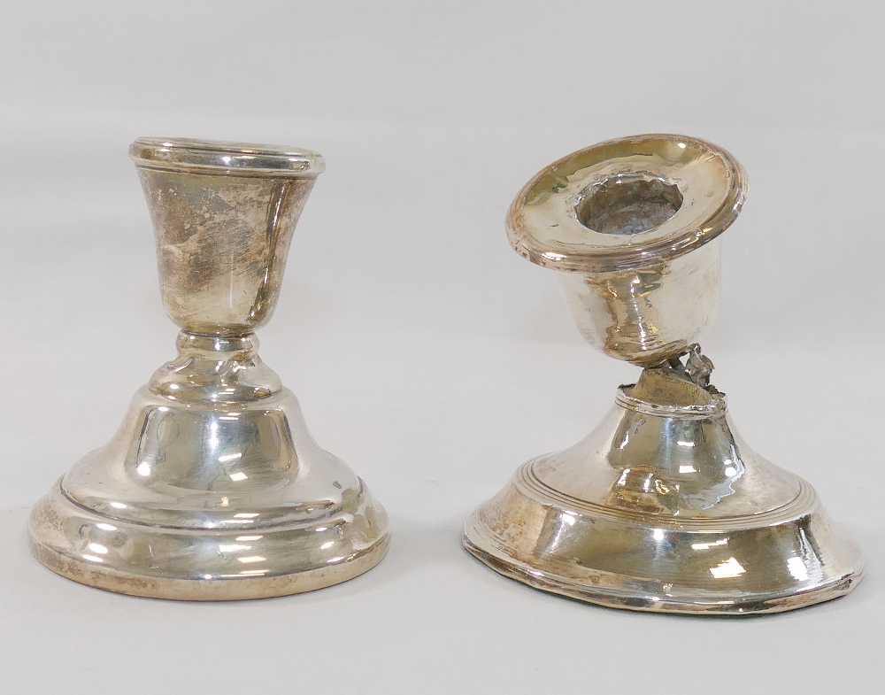 Two squat silver candlesticks, with loaded bases, both at faultCONDITION REPORTS & PAYMENT