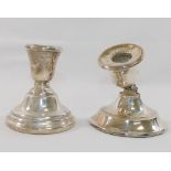 Two squat silver candlesticks, with loaded bases, both at faultCONDITION REPORTS & PAYMENT