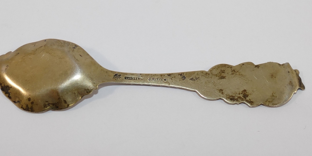 An ornate gilt spoon stamped 'sterling' by J Ritter, a small silver butter knife, a silver napkin - Image 4 of 6