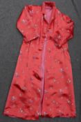 A vintage red satin ladies dressing gown with chinoiserie floral machine embroidered decoration, and