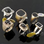 A collection of 12 black onyx set rings, most stamped 'silver' or '925', including a range of