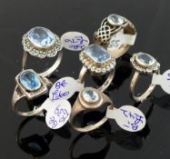 A collection of 12 Swiss blue topaz set rings, including some set with marcasite, most stamped '