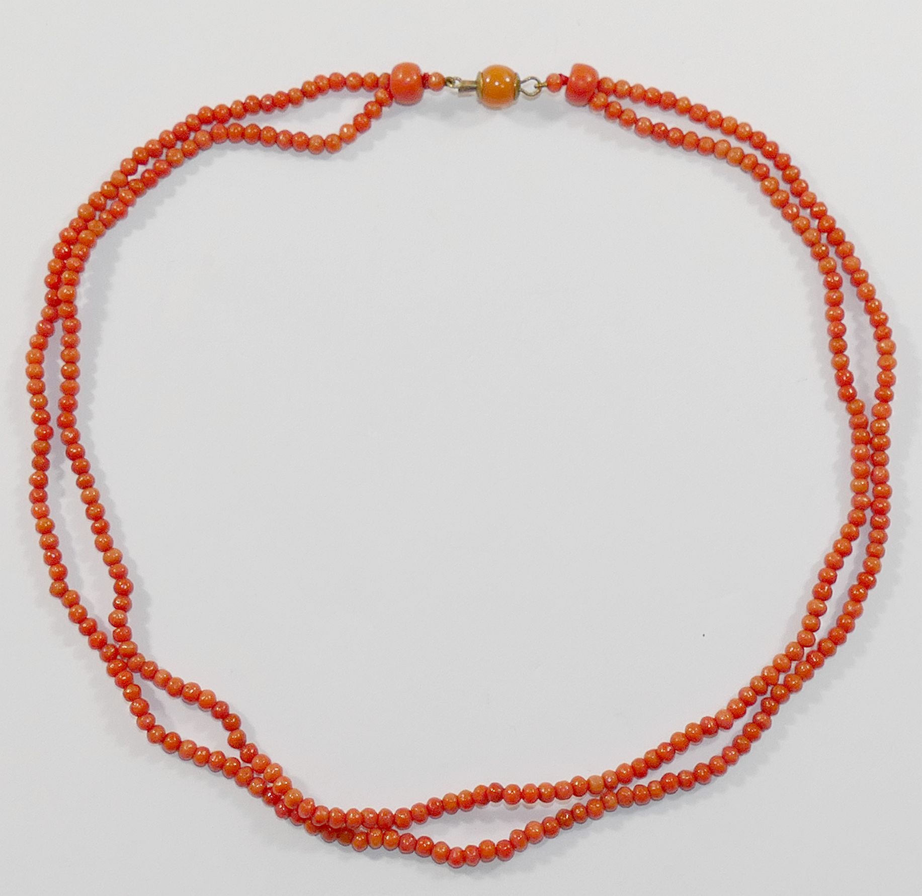 A Victorian double row coral necklace, the small oval beads each approximately 2.5mm diameter,