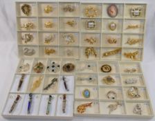 60 gold plated, paste set and other costume brooches, housed in presentation boxes. We are pleased